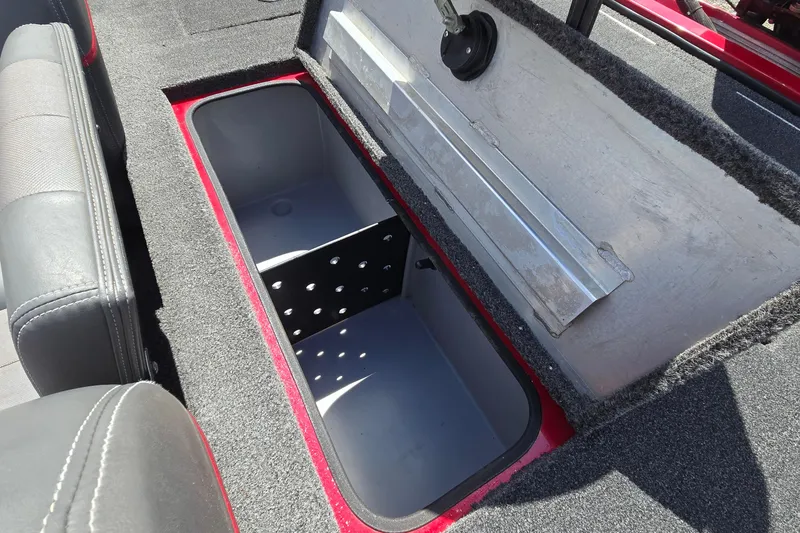 Slide: The Image of Open storage compartment in 2013 Ranger RT188 boat, featuring carpeted interior and seating. - 14