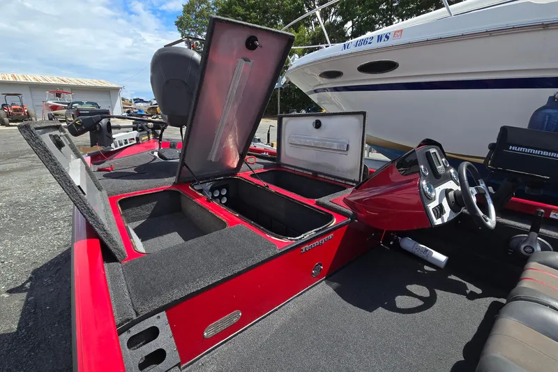 Slide: The Image of 2013 Ranger RT188 boat interior with open storage compartments and steering console. - 15