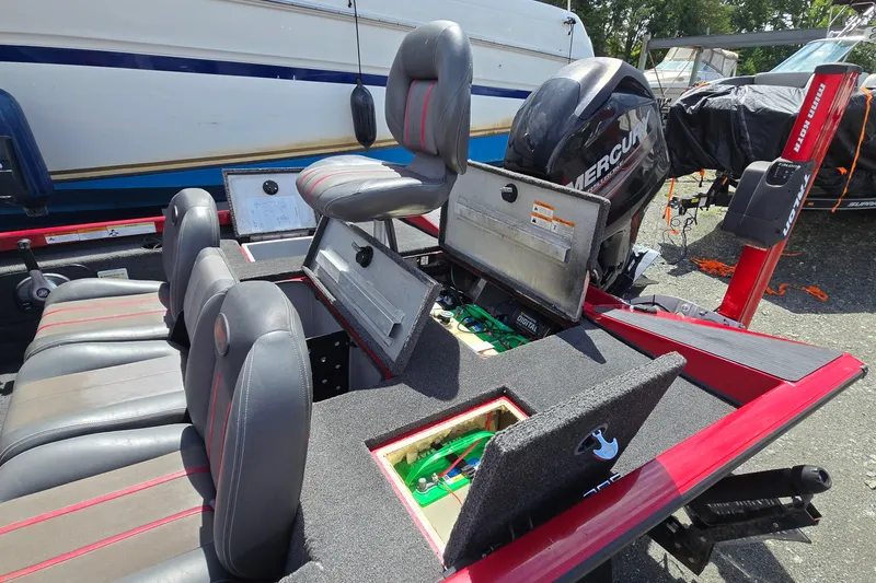 Slide: The Image of 2013 Ranger RT188 boat interior with Mercury engine, featuring seating and storage compartments. - 16
