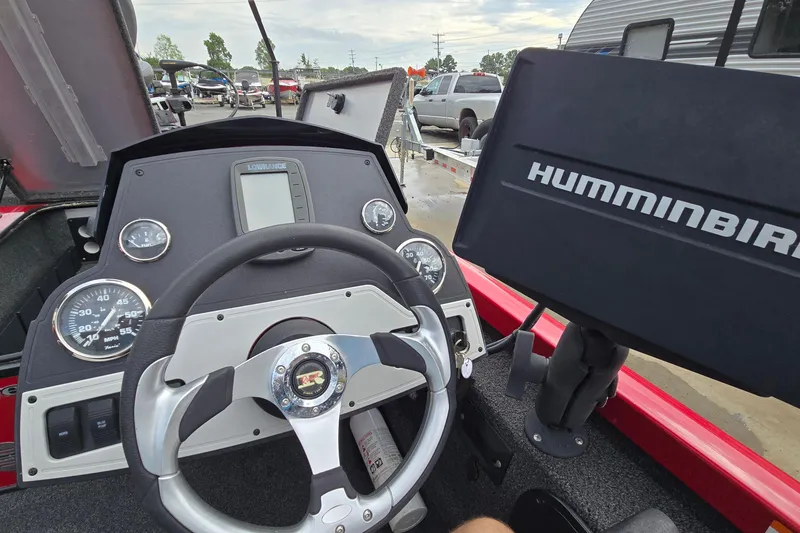 Slide: The Image of 2013 Ranger RT188 boat dashboard with steering wheel and Humminbird fish finder. - 19