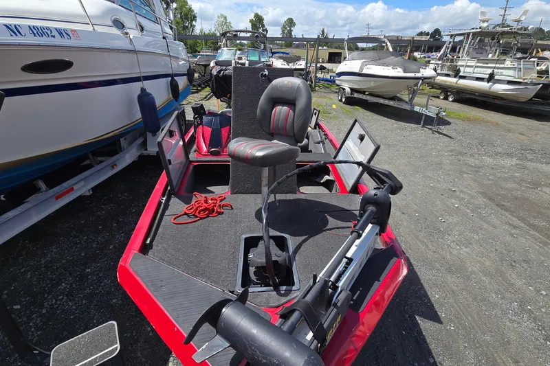 Slide: The Image of 2013 Ranger RT188 boat in a marina, featuring a red and black design. - 2