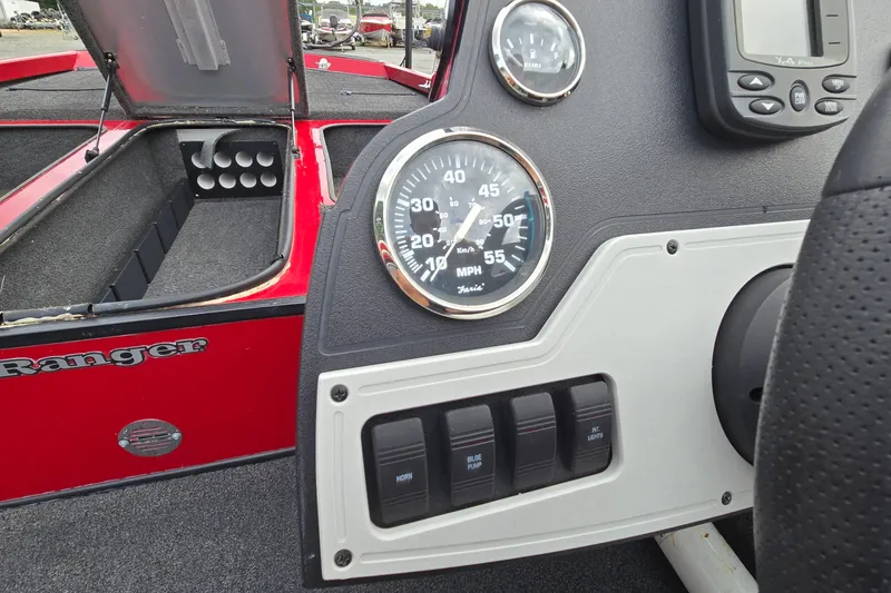 Slide: The Image of Dashboard of a 2013 Ranger RT188 boat with speedometer and control switches. - 20