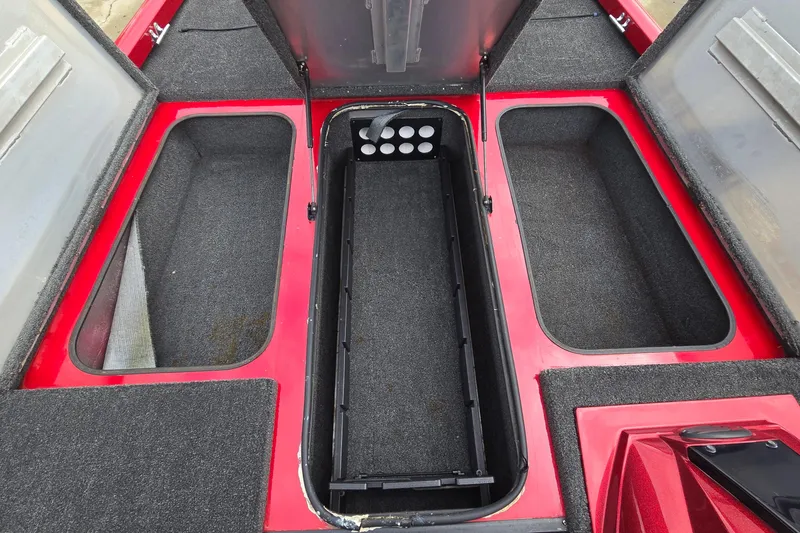 Slide: The Image of 2013 Ranger RT188 boat storage compartments with open lids, featuring red and gray interior. - 23