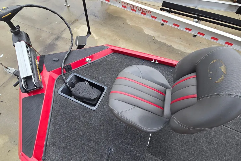 Slide: The Image of 2013 Ranger RT188 boat interior with gray and red seat, foot pedal, and trolling motor. - 24