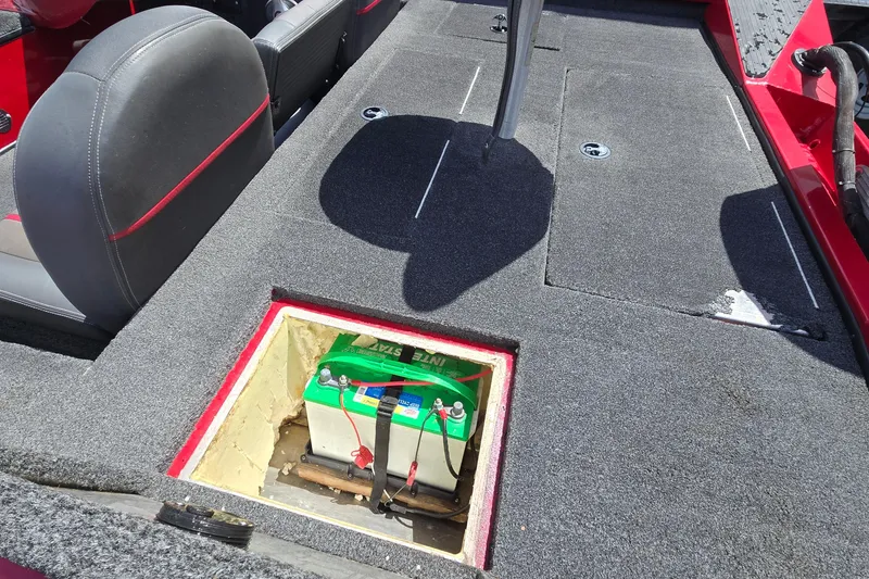 Slide: The Image of 2013 Ranger RT188 boat interior showing battery compartment under carpeted deck. - 33