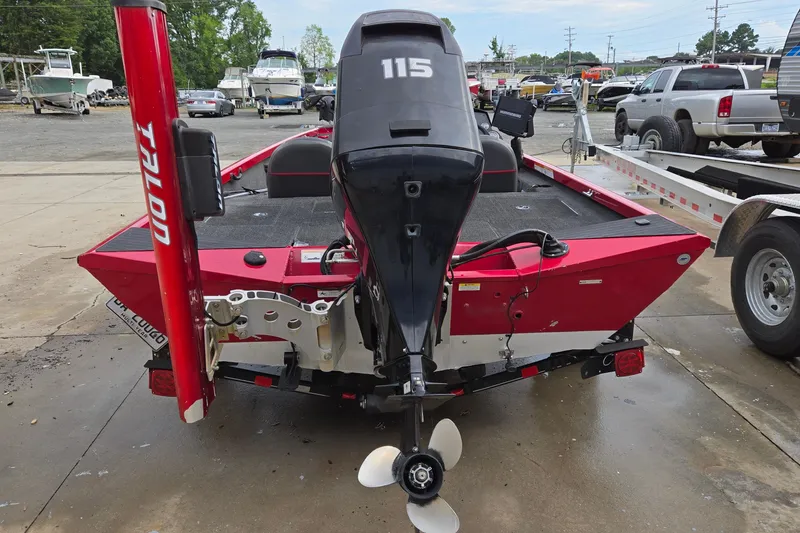 Slide: The Image of 2013 Ranger RT188 boat with 115 HP motor, red exterior, parked in a marina. - 5
