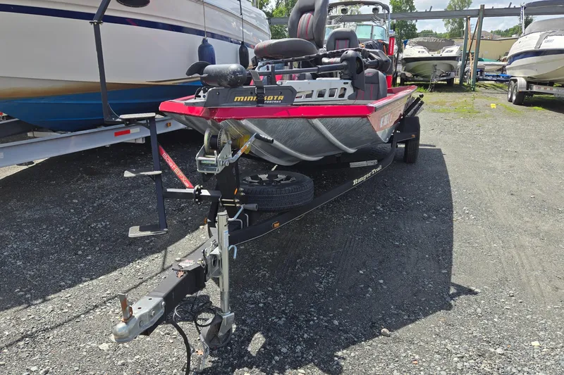 Slide: The Image of 2013 Ranger RT188 boat on trailer in a marina parking lot. - 6