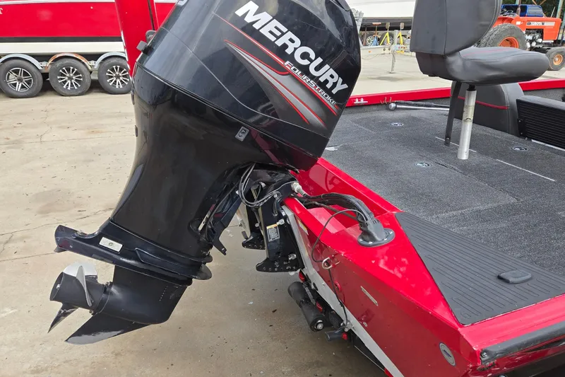 Slide: The Image of Red 2013 Ranger RT188 boat with Mercury FourStroke outboard motor, parked on concrete. - 7