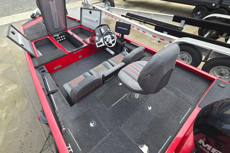 Slide: The Image of 2013 Ranger RT188 boat interior with seating, storage, and steering console. - 9