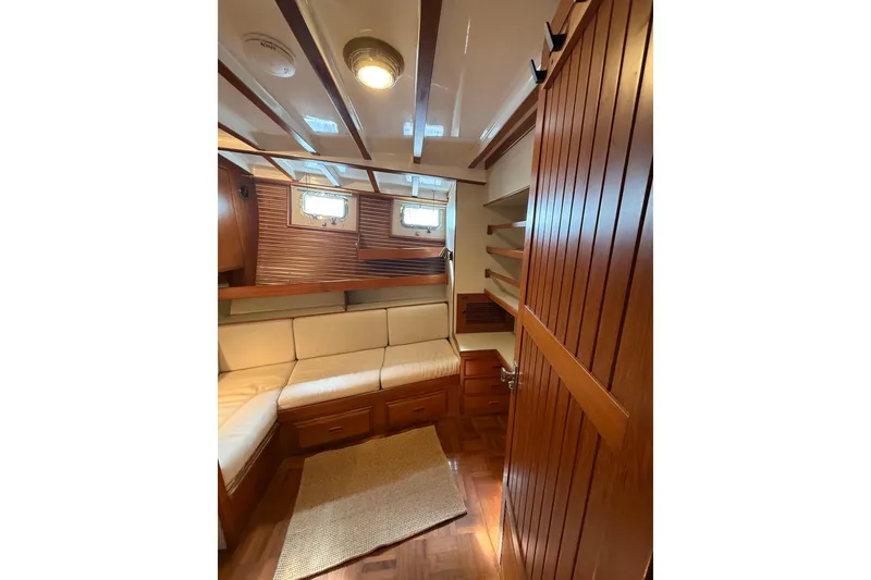 Slide: The Image of 1994 Kadey-Krogen Krogen 42 yacht interior with wooden paneling and cozy seating area. - 18