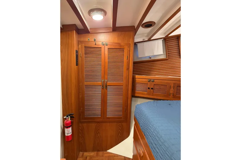 Slide: The Image of Cozy cabin interior of 1994 Kadey-Krogen Krogen 42 with wooden cabinetry and blue bedding. - 10