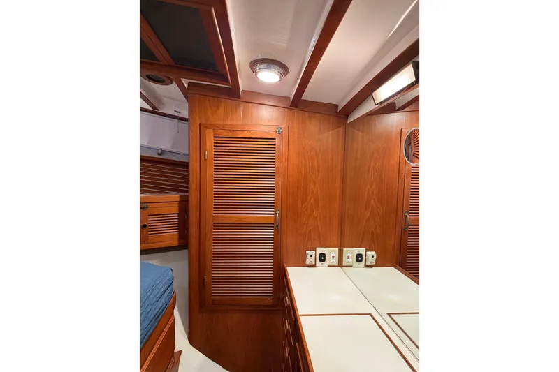 Slide: The Image of 1994 Kadey-Krogen Krogen 42 yacht interior with wooden cabinetry and mirror. - 11