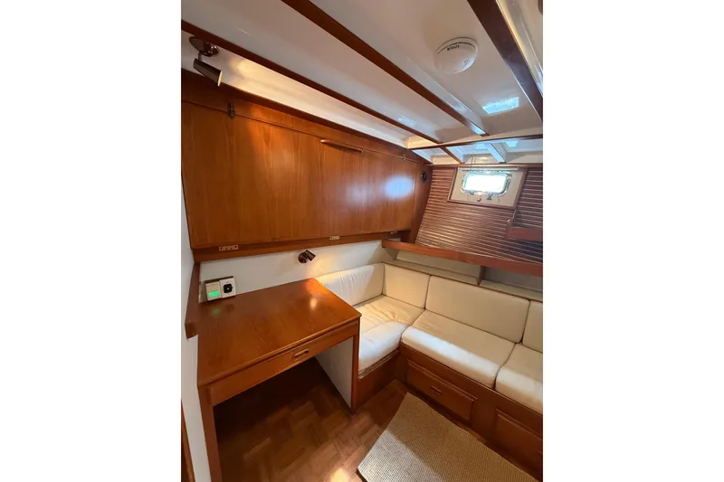 Slide: The Image of Cozy interior of 1994 Kadey-Krogen Krogen 42 yacht with wooden cabinetry and cushioned seating. - 15