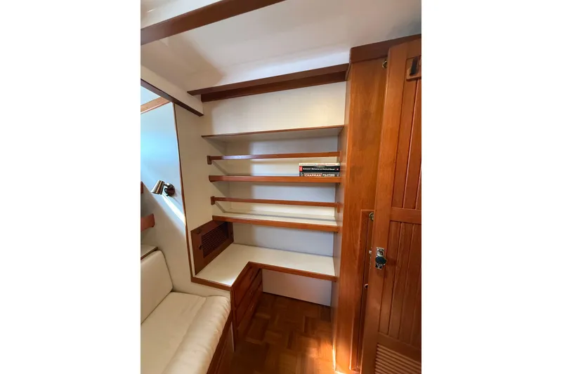 Slide: The Image of 1994 Kadey-Krogen Krogen 42 interior with wooden shelves and seating area. - 17