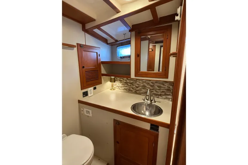 Slide: The Image of 1994 Kadey-Krogen Krogen 42 yacht bathroom with wood cabinetry and stainless steel sink. - 20