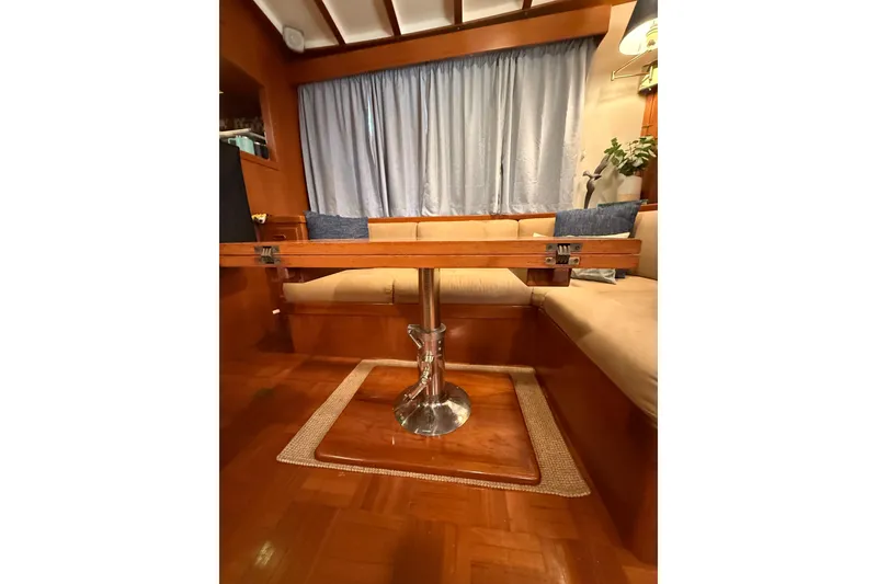 Slide: The Image of Interior of 1994 Kadey-Krogen Krogen 42 yacht with wooden table and cushioned seating. - 7