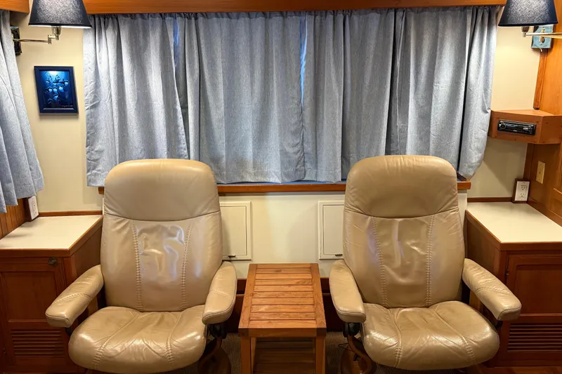 Slide: The Image of Two beige leather chairs in a 1994 Kadey-Krogen Krogen 42 yacht interior. - 8
