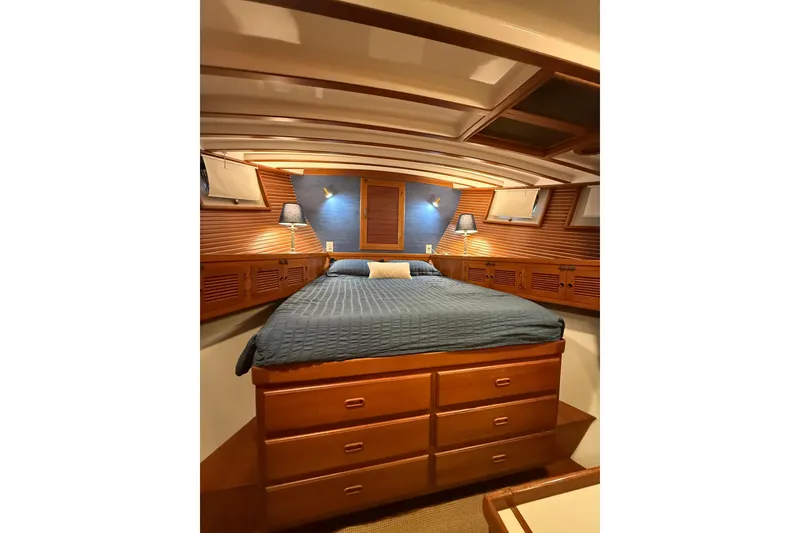 Slide: The Image of Luxurious 1994 Kadey-Krogen Krogen 42 yacht bedroom with wood paneling and cozy bedding. - 9