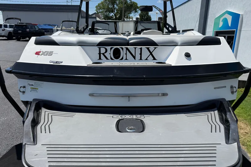 Slide: The Image of 2014 Axis A22 boat rear view with Ronix branding and swim platform. - 15