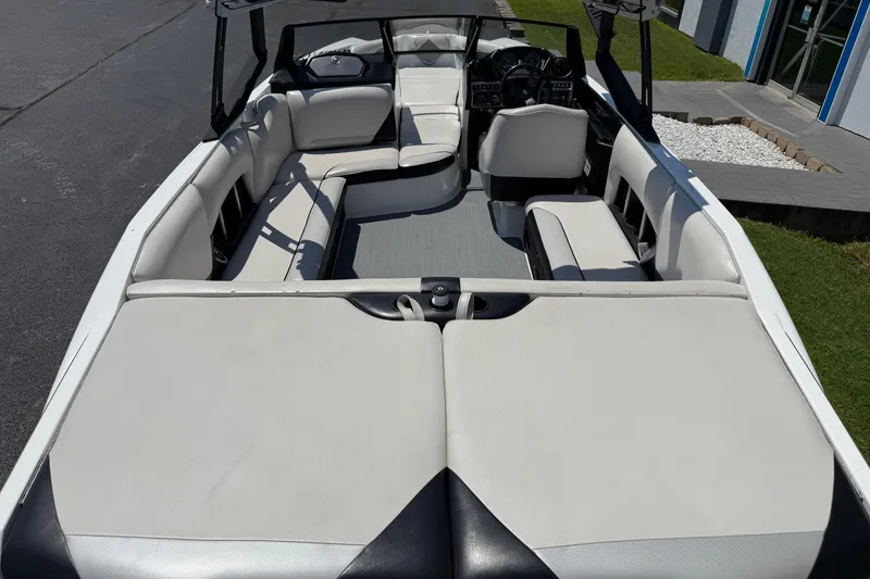 Slide: The Image of 2014 Axis A22 boat interior with white seating and modern dashboard. - 16