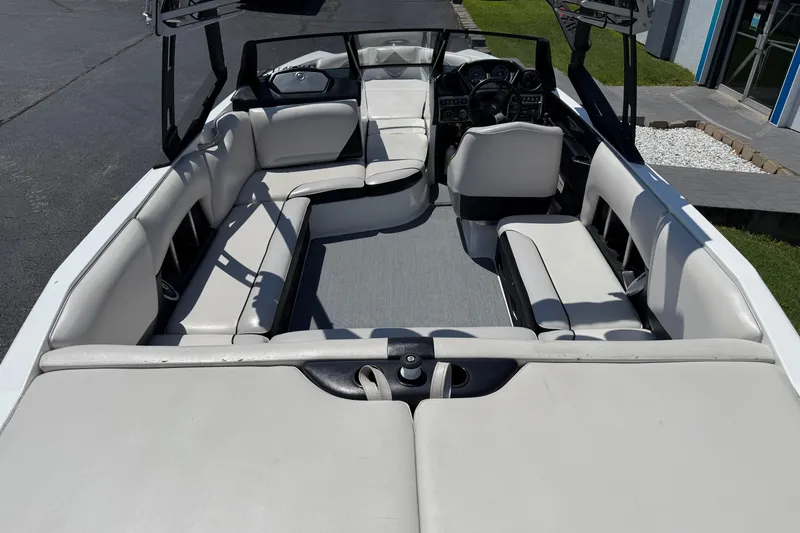 Slide: The Image of 2014 Axis A22 boat interior with white seating and modern dashboard. - 17