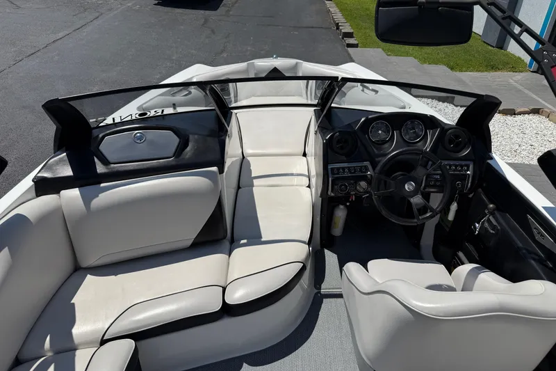 Slide: The Image of 2014 Axis A22 boat interior with steering wheel, dashboard, and seating. - 19
