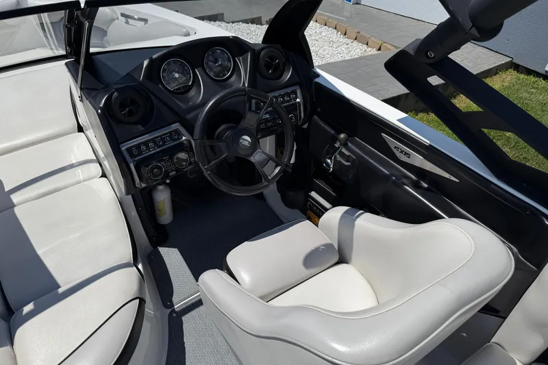 Slide: The Image of 2014 Axis A22 boat interior with steering wheel and white seating. - 20