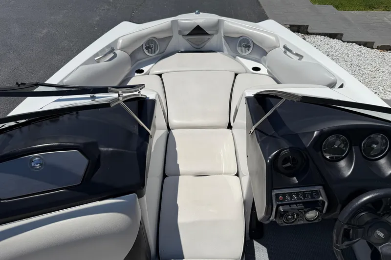 Slide: The Image of 2014 Axis A22 boat interior with white seating and black dashboard. - 22