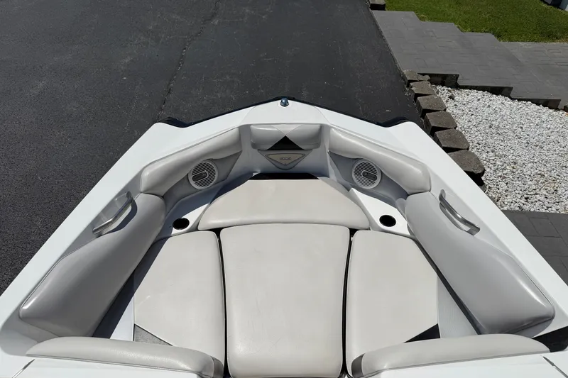 Slide: The Image of 2014 Axis A22 boat interior with white cushioned seating and built-in speakers. - 24