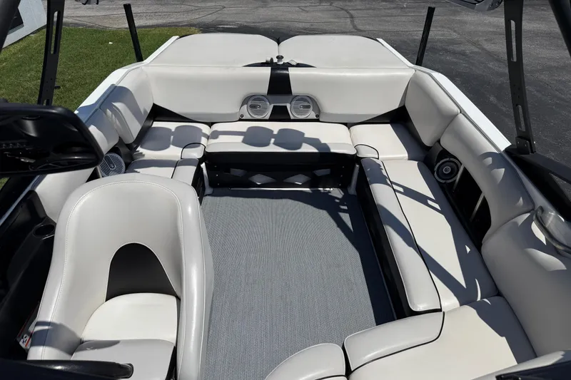 Slide: The Image of 2014 Axis A22 boat interior with white seating and speakers. - 26