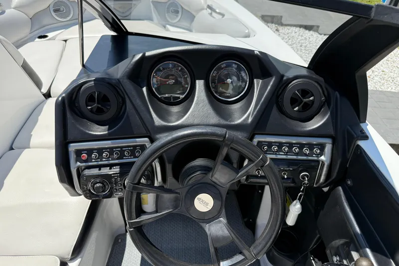 Slide: The Image of 2014 Axis A22 boat dashboard with steering wheel and control panel. - 27