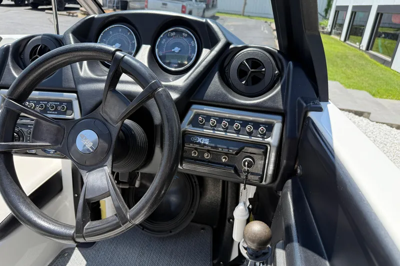 Slide: The Image of 2014 Axis A22 boat dashboard with steering wheel and control panel. - 29