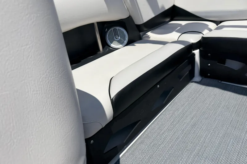 Slide: The Image of 2014 Axis A22 boat interior with cushioned seating and speaker detail. - 31