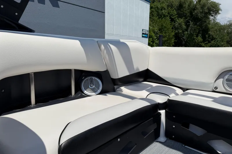 Slide: The Image of 2014 Axis A22 boat interior with white and black seating and built-in speakers. - 32