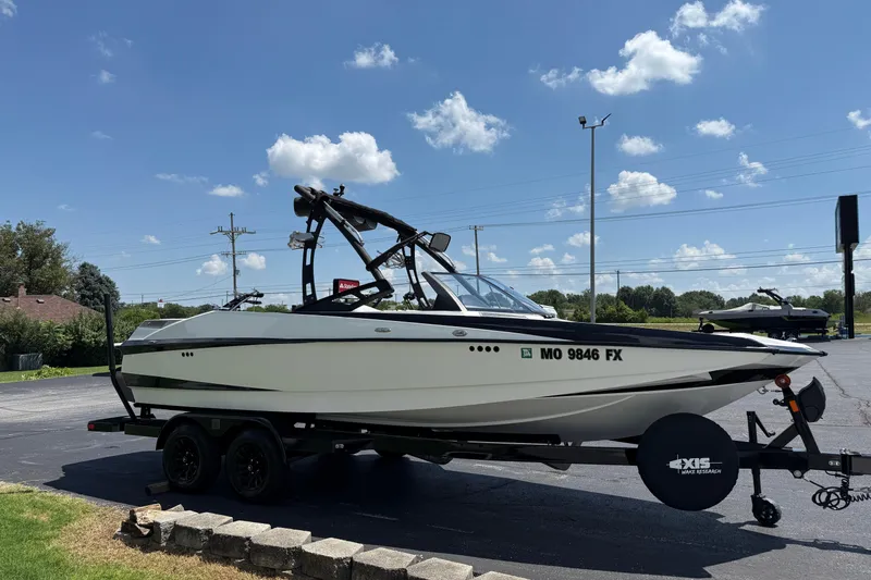 Slide: The Image of 2014 Axis A22 boat on trailer under clear blue sky. - 7