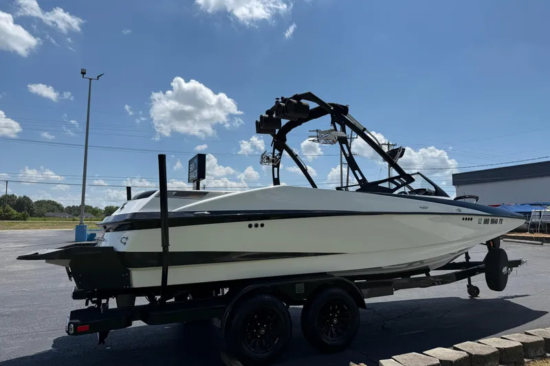 Slide: The Image of 2014 Axis A22 boat on trailer under clear blue sky. - 9