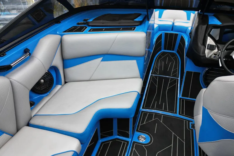 Slide: The Image of 2020 Centurion Fi25 interior with blue and gray seating, modern design, and sleek flooring. - 11