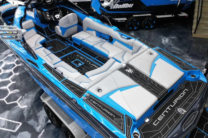 Slide: The Image of 2020 Centurion Fi25 boat interior with blue and white seating, sleek design, and modern features. - 13