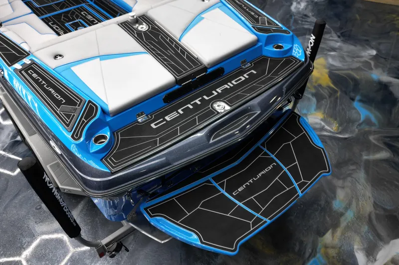 Slide: The Image of 2020 Centurion Fi25 boat with sleek blue and black design, featuring branded deck. - 15