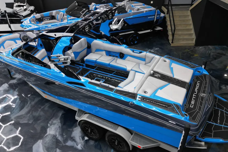 Slide: The Image of 2020 Centurion Fi25 boat with blue and gray interior on display in showroom. - 5
