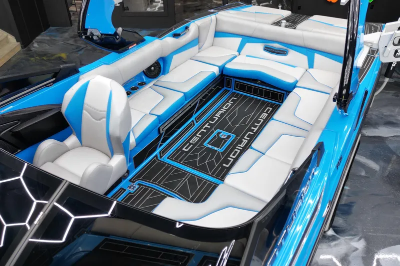 Slide: The Image of 2020 Centurion Fi25 boat interior with blue and white seating, modern design, and branding details. - 9