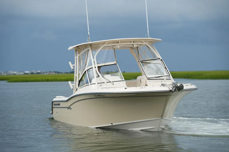 Slide: The Image of 2018 Grady-White Freedom 235 boat cruising on calm waters. - 10