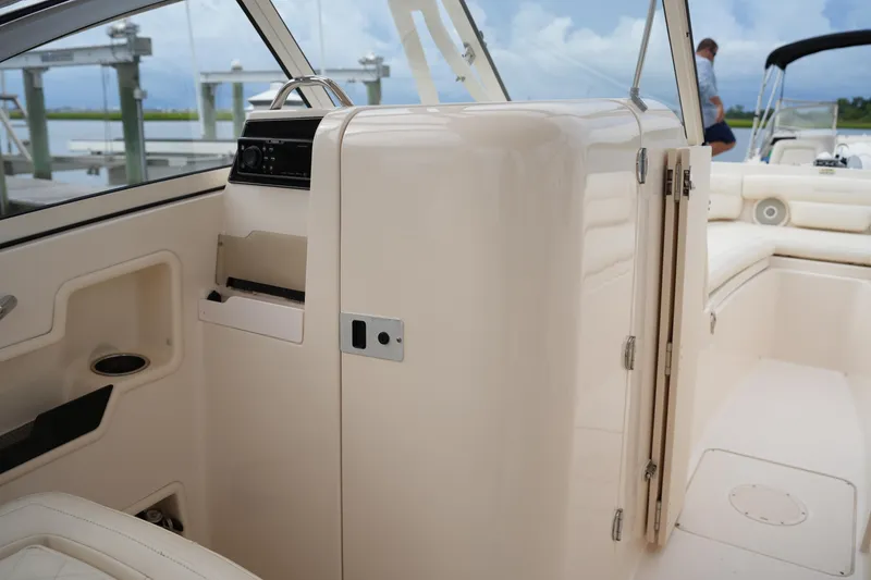 Slide: The Image of 2018 Grady-White Freedom 235 boat interior with seating and storage compartments. - 22