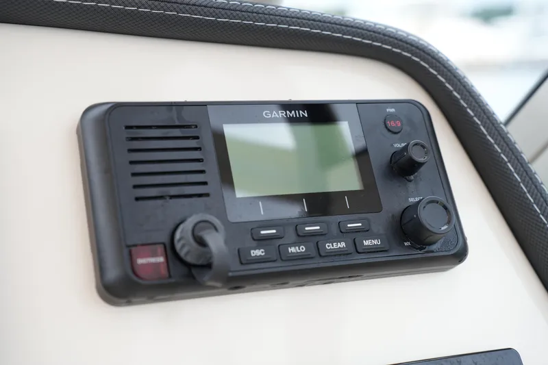 Slide: The Image of Garmin marine radio on 2018 Grady-White Freedom 235 boat dashboard. - 25