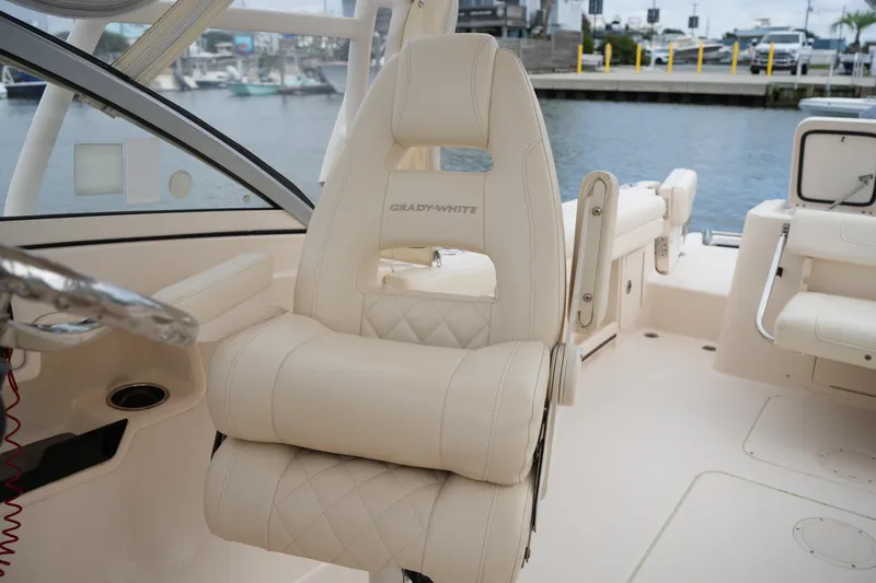 Slide: The Image of 2018 Grady-White Freedom 235 boat interior with luxurious seating and steering wheel. - 30