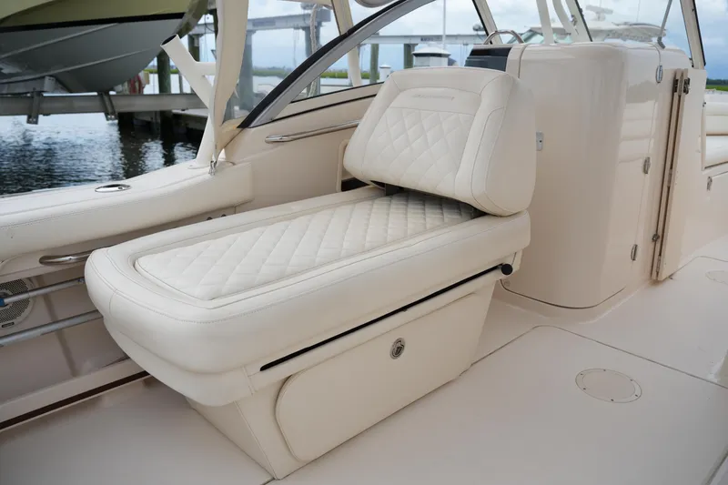 Slide: The Image of 2018 Grady-White Freedom 235 boat interior with luxurious white seating and storage. - 32