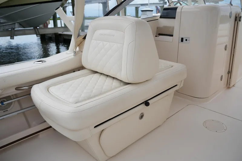 Slide: The Image of 2018 Grady-White Freedom 235 boat interior with luxurious white seating. - 33