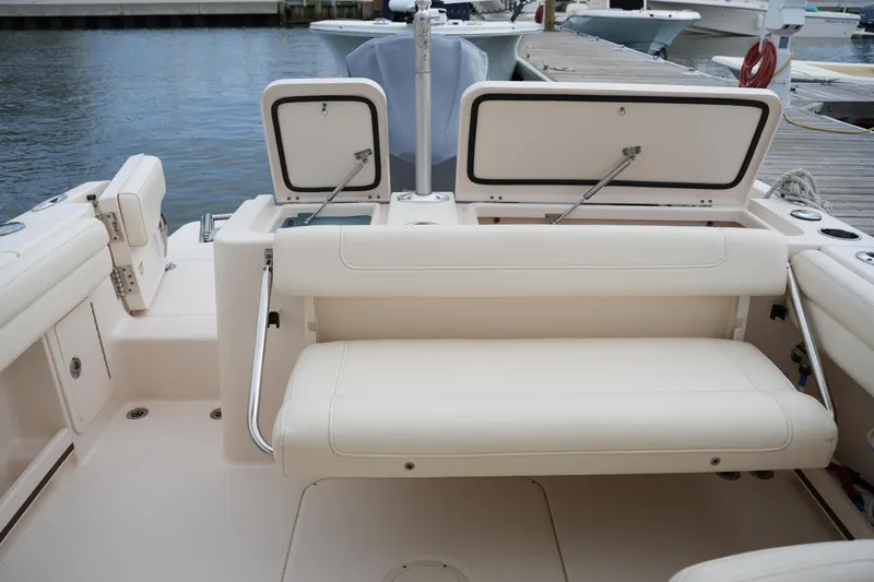 Slide: The Image of 2018 Grady-White Freedom 235 boat interior with open storage compartments and seating. - 34