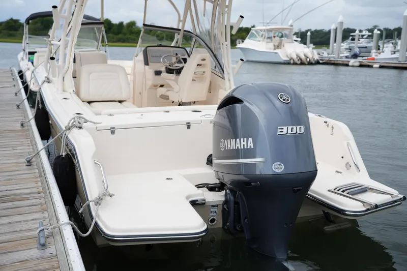 Slide: The Image of 2018 Grady-White Freedom 235 boat with Yamaha 300 engine docked at marina. - 36