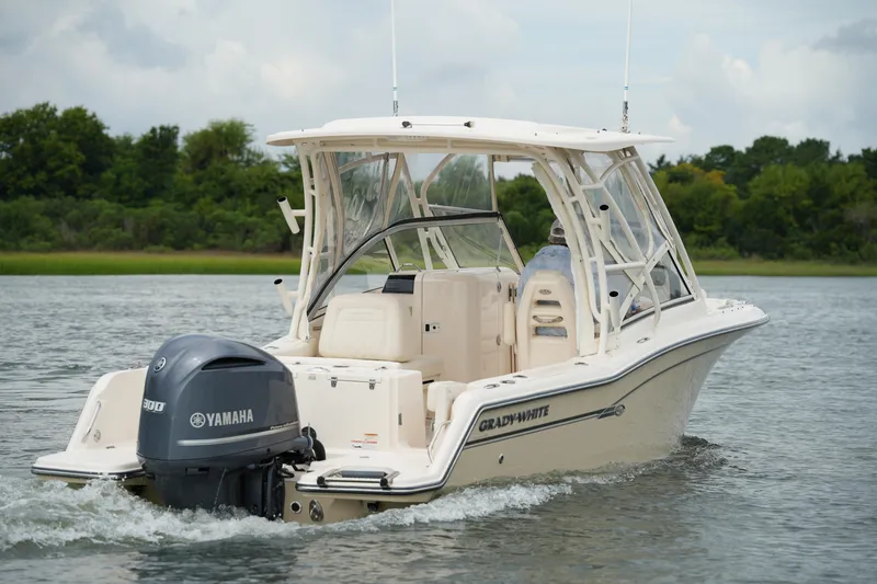 Slide: The Image of 2018 Grady-White Freedom 235 boat with Yamaha engine cruising on a calm lake. - 5